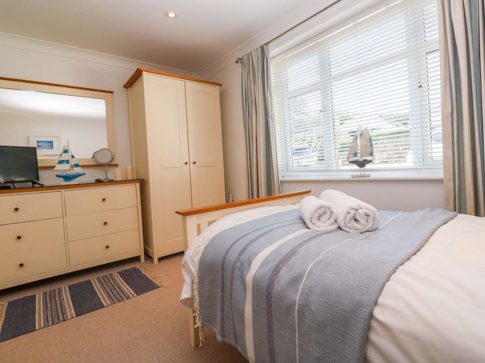 A bedroom with a bed and dresser at Sea Breeze in Carbis Bay