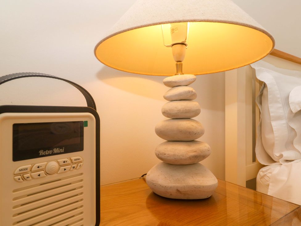 A lamp and radio on a nightstand at Sea Breeze in Carbis Bay