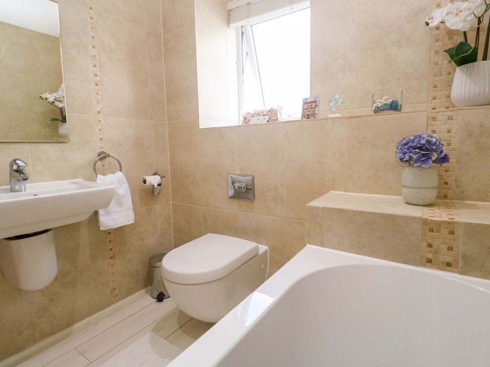 A bathroom with sink, toilet, and bath at Sea Breeze in Carbis Bay
