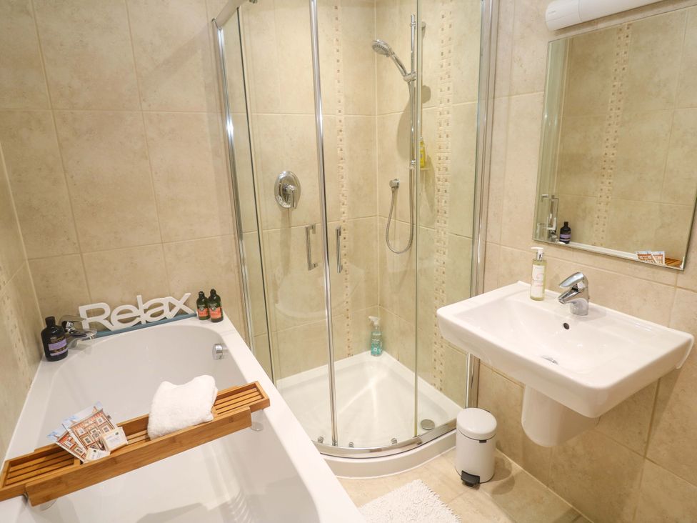 A bathroom with a bathtub and shower at Sea Breeze in Carbis Bay