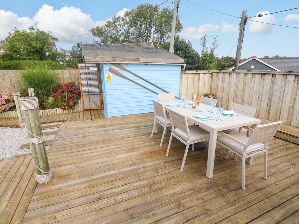 An outdoor dining area with a table and chairs at Sea Breeze, Carbis Bay