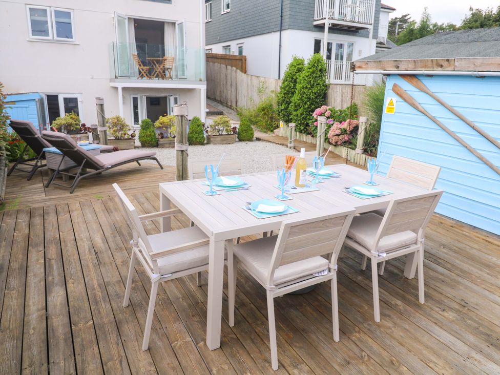An outdoor dining area with a table and chairs at Sea Breeze in Carbis Bay