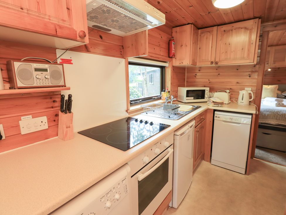 A kitchen with appliances and countertop at Squirrels Leap Number 29, Burnside Park near Keswick