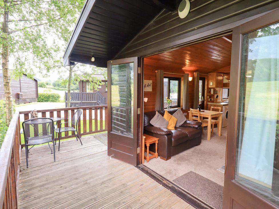 A living room and balcony area at Squirrels Leap, Number 29, Burnside Park near Keswick