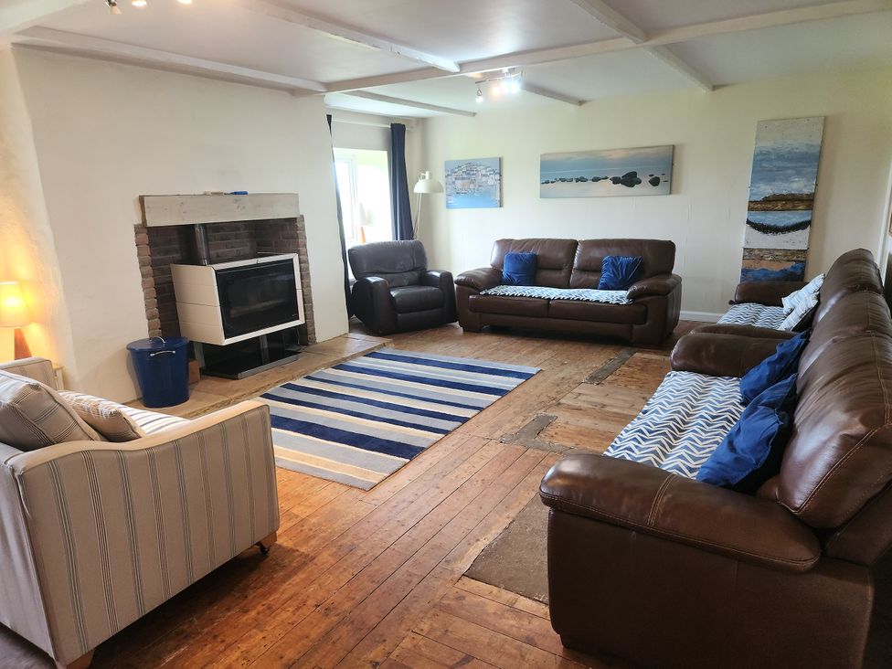A living room with sofas and a fireplace at ASTA COTTAGE in Cresswell