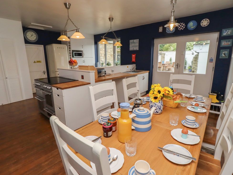 A kitchen with a dining table and chairs at ASTA COTTAGE in Cresswell