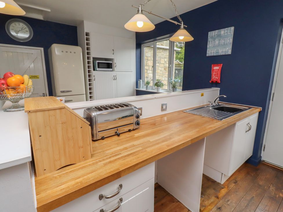 A kitchen with a toaster and sink at ASTA COTTAGE in Cresswell