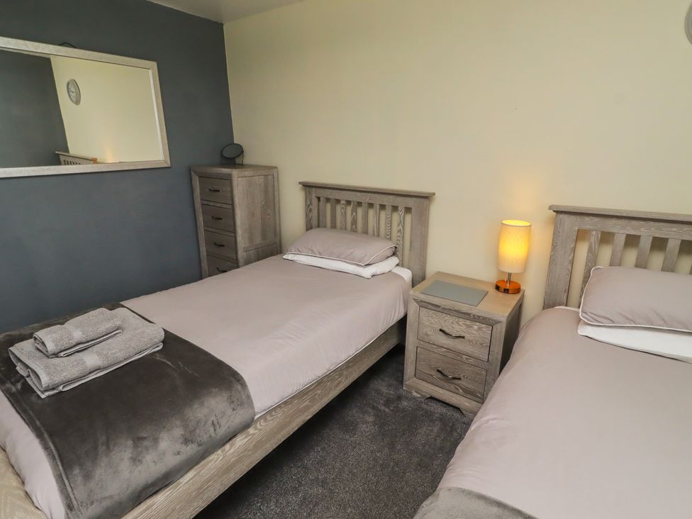 A bedroom with two beds and a chest of drawers at ASTA COTTAGE in Cresswell