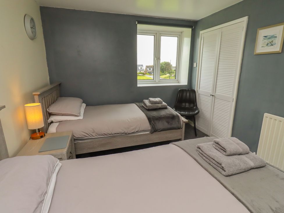 A bedroom with two beds and a window at ASTA COTTAGE Cresswell
