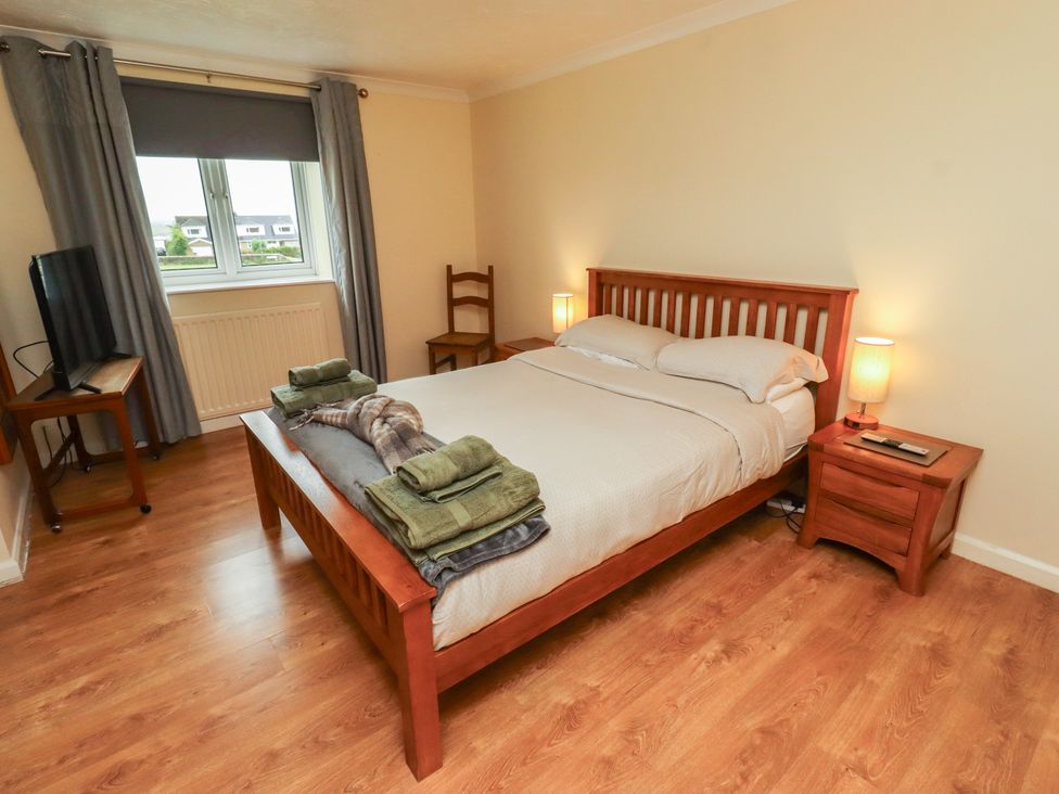 A bedroom with a bed and television at ASTA COTTAGE in Cresswell