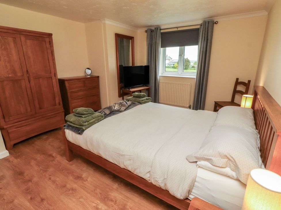 A bedroom with a bed and a television at ASTA COTTAGE in Cresswell