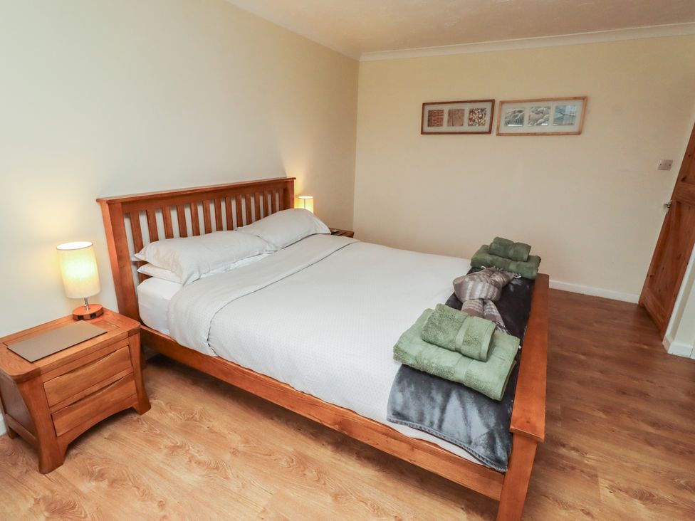 A bedroom with a bed and nightstand at ASTA COTTAGE Cresswell