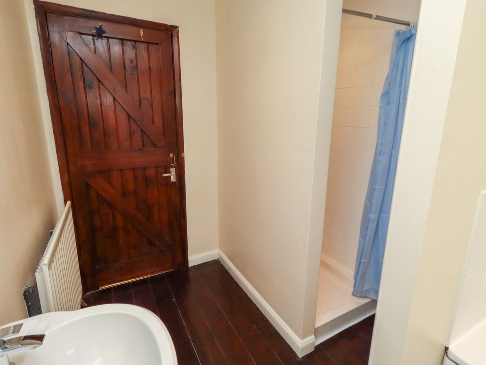 A bathroom with a shower and sink at ASTA COTTAGE in Cresswell