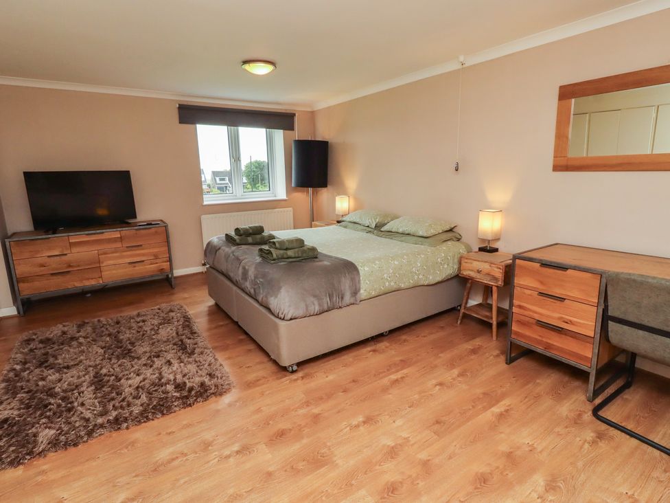 A bedroom with a bed and television at ASTA COTTAGE in Cresswell