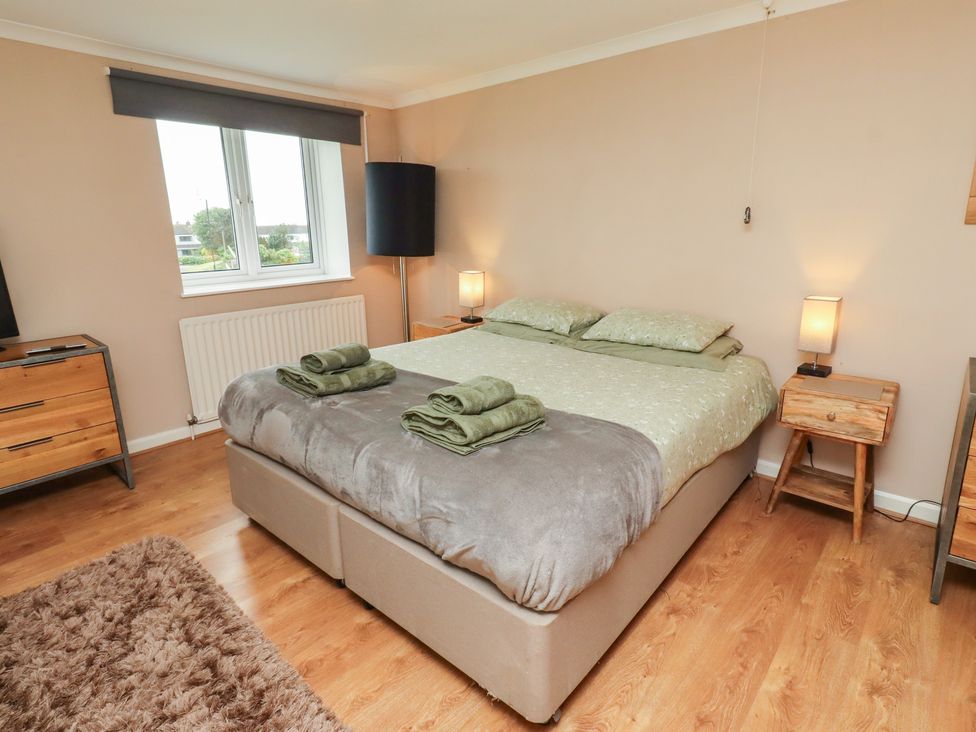 A bedroom with a bed and nightstands at ASTA COTTAGE in Cresswell