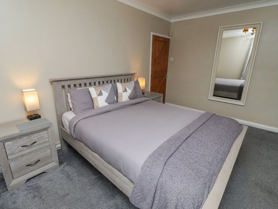 A bedroom with a bed and bedside tables at ASTA COTTAGE Cresswell