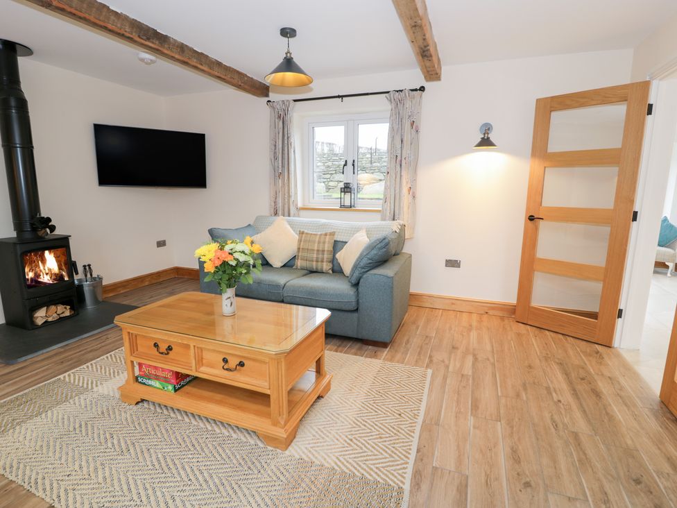 A living room with a sofa and coffee table at Merddwr Cerrigydrudion