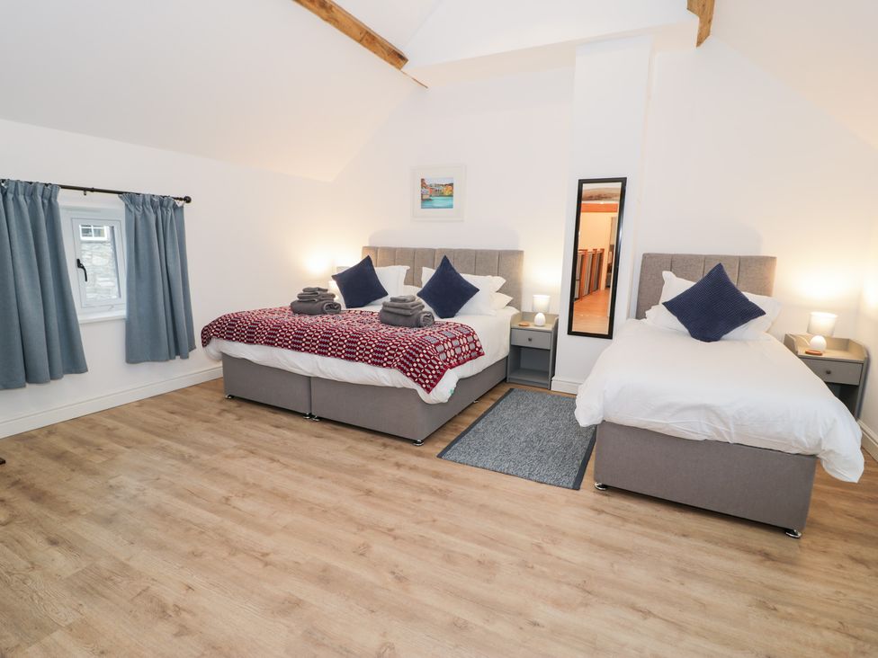 A bedroom with two beds and nightstands at Merddwr in Cerrigydrudion