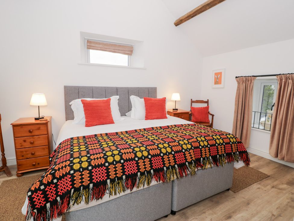 A bedroom with a double bed and bedside lamps at Merddwr in Cerrigydrudion