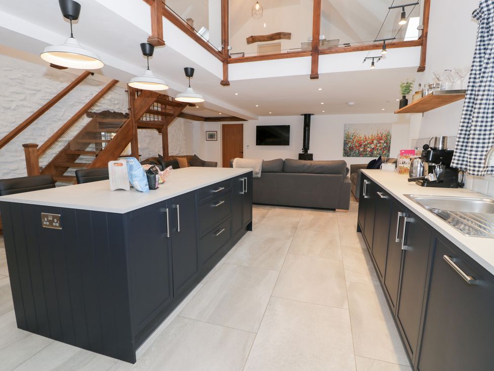A kitchen with an island and sofa at Merddwr in Cerrigydrudion