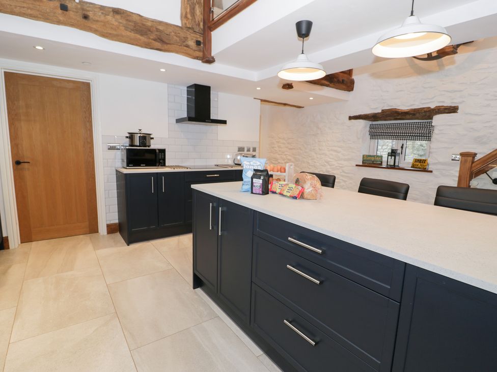 A kitchen with countertop and storage cabinets at Merddwr in Cerrigydrudion