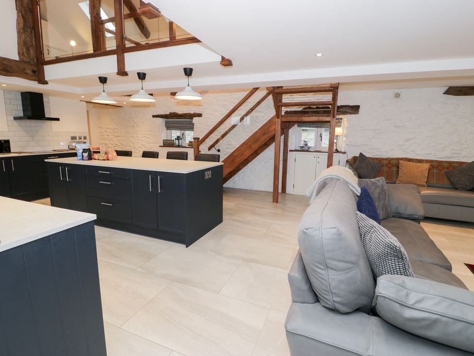 A kitchen with a kitchen island and sofa at Merddwr in Cerrigydrudion