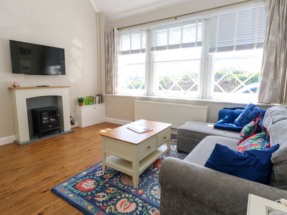 A living room with a sofa and coffee table at Sea Pink Cottage in Langton Matravers