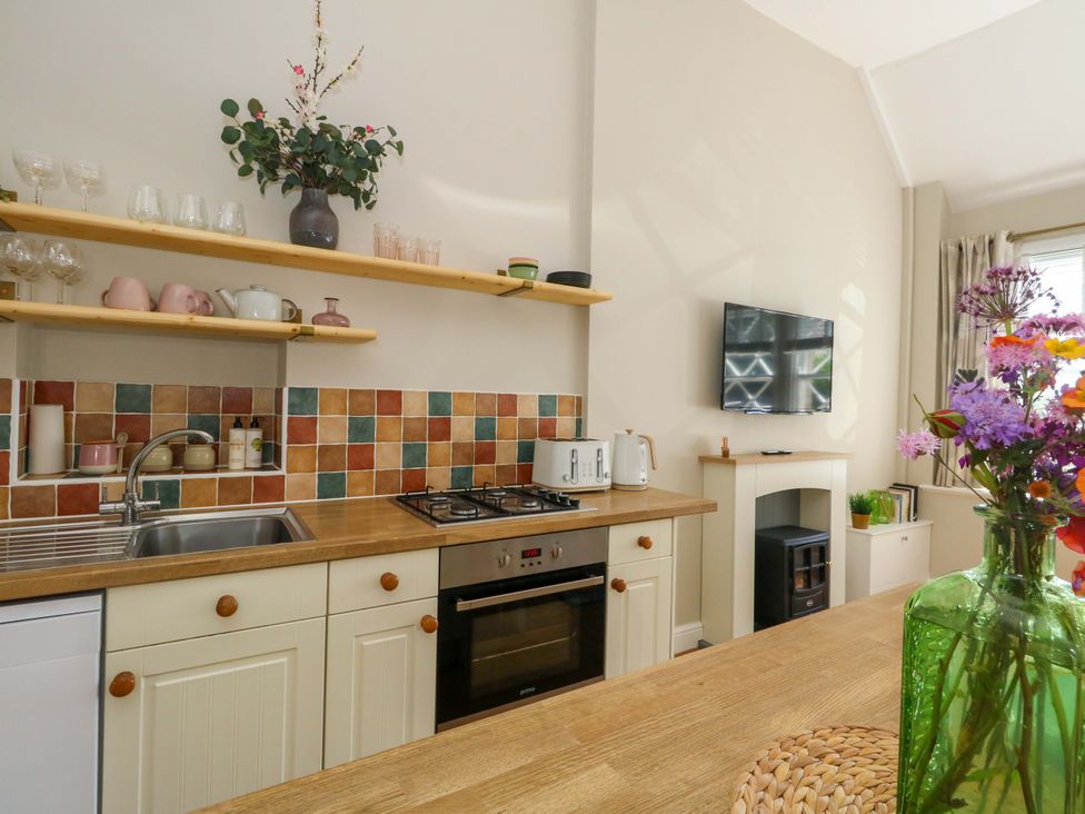 A kitchen with appliances and decor at Sea Pink Cottage in Langton Matravers