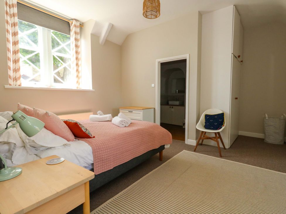 A bedroom with a bed and lamp at Sea Pink Cottage in Langton Matravers