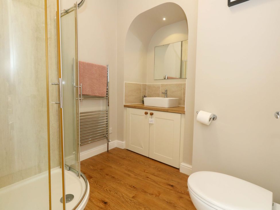 A bathroom with a shower, sink, and toilet at Sea Pink Cottage in Langton Matravers