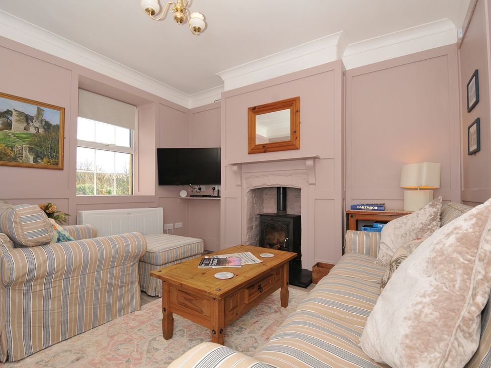 A living room with a television and fireplace at Tor View @ Fourwinds, Meldon near Okehampton