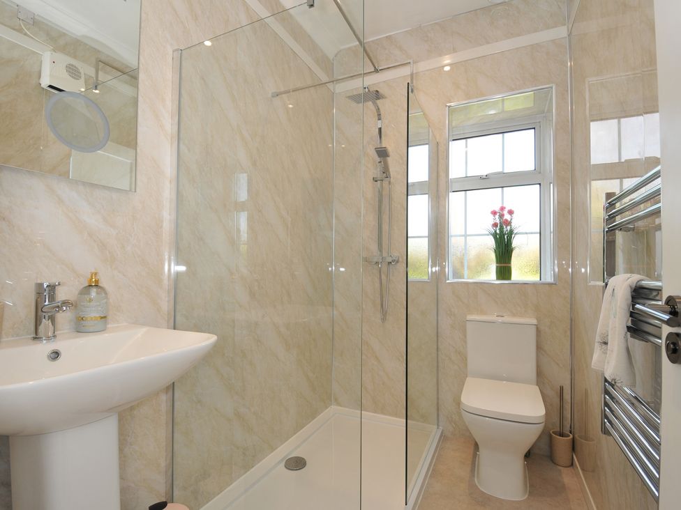 A bathroom with a shower, sink, and toilet at Tor View @ Fourwinds in Meldon near Okehampton