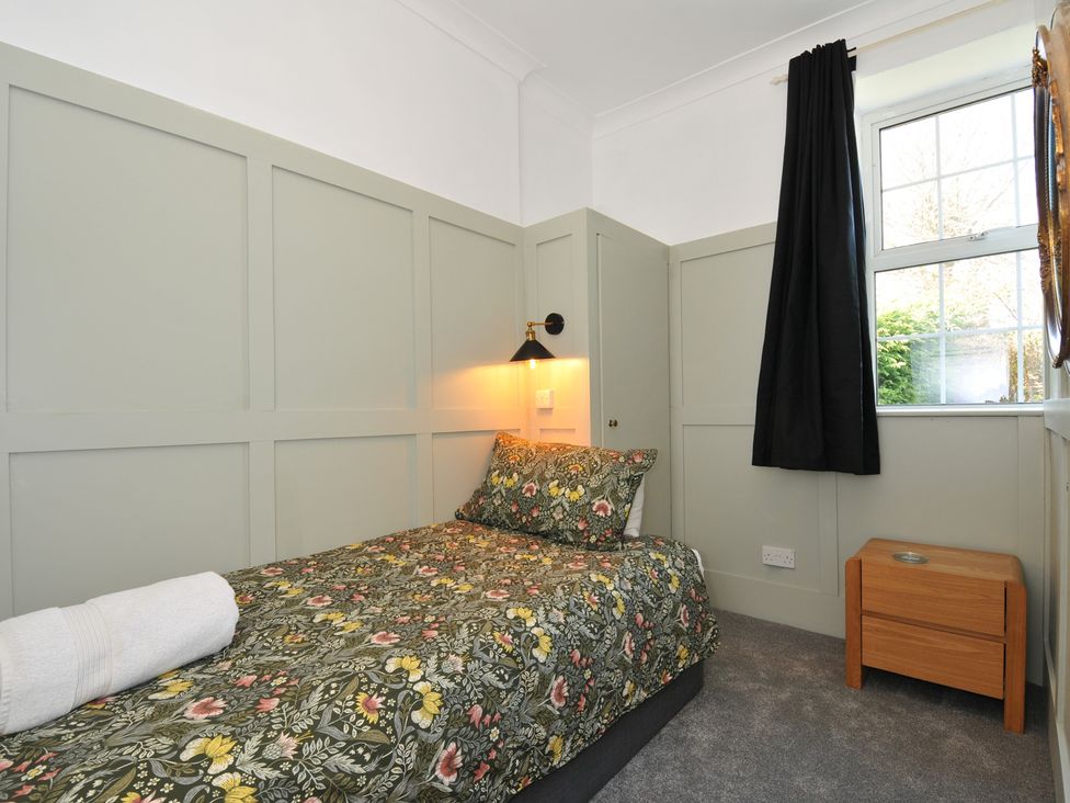 A bedroom with a bed and a window at Tor View @ Fourwinds in Meldon near Okehampton