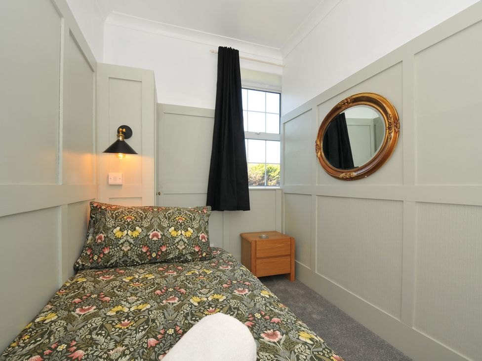 A bedroom with a bed and a nightstand at Tor View @ Fourwinds Meldon near Okehampton