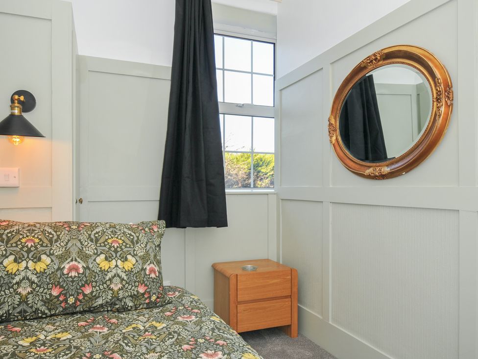 A bedroom with a bed and nightstand at Tor View @ Fourwinds in Meldon near Okehampton
