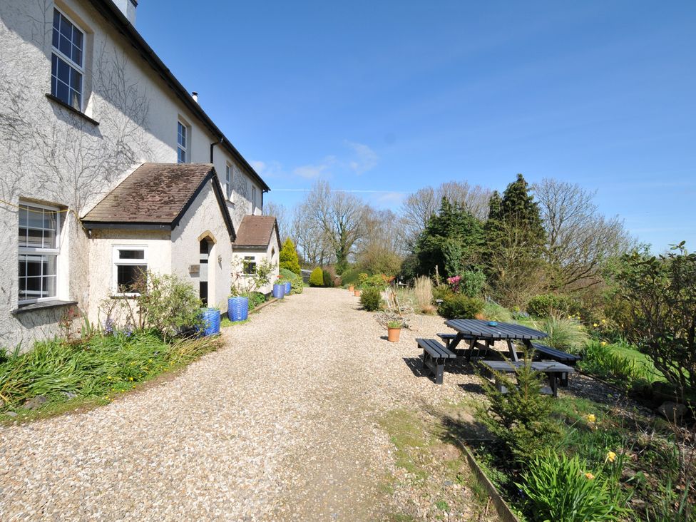 A garden pathway with seating and plants at Tor View @ Fourwinds in Meldon near Okehampton