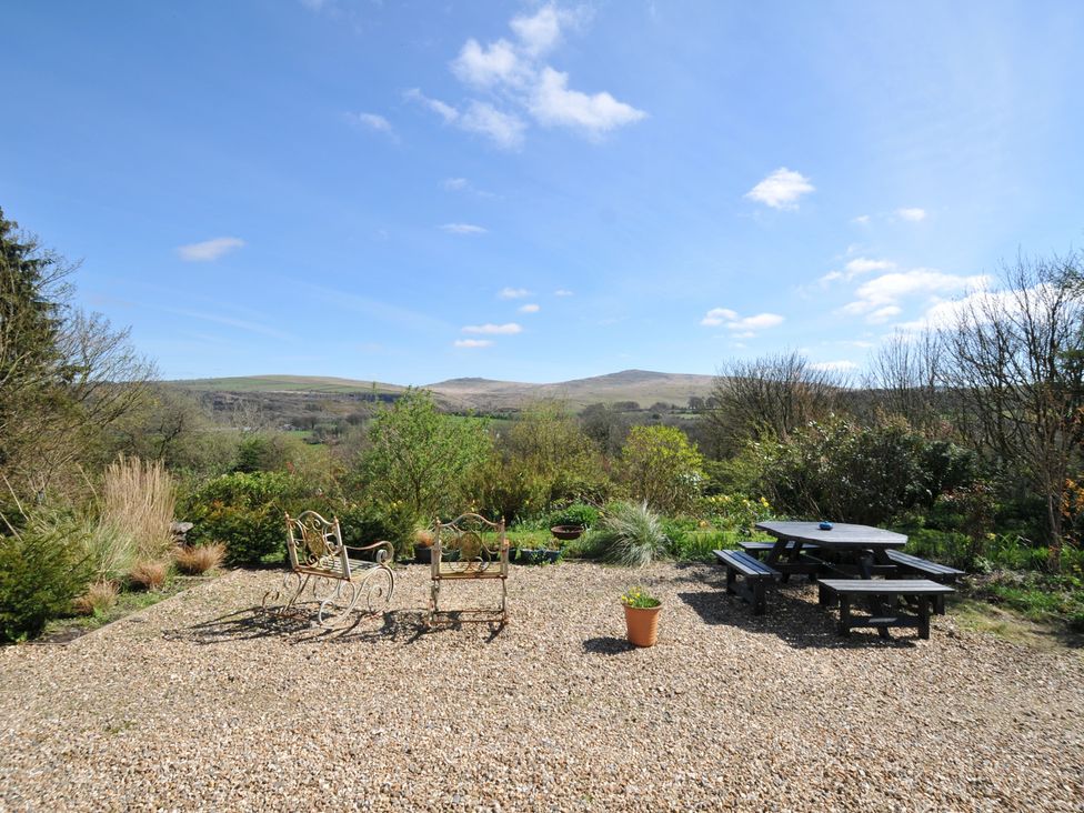 A garden with chairs and a table at Tor View @ Fourwinds in Meldon near Okehampton
