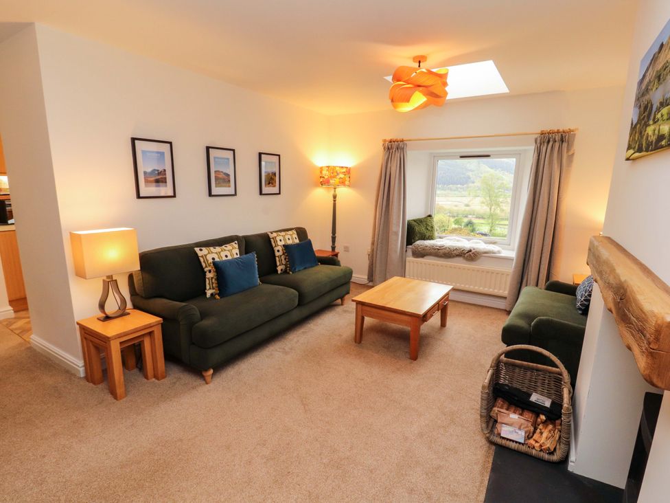 A living room with sofas and a coffee table at Swallow's Nest in Thornthwaite near Braithwaite
