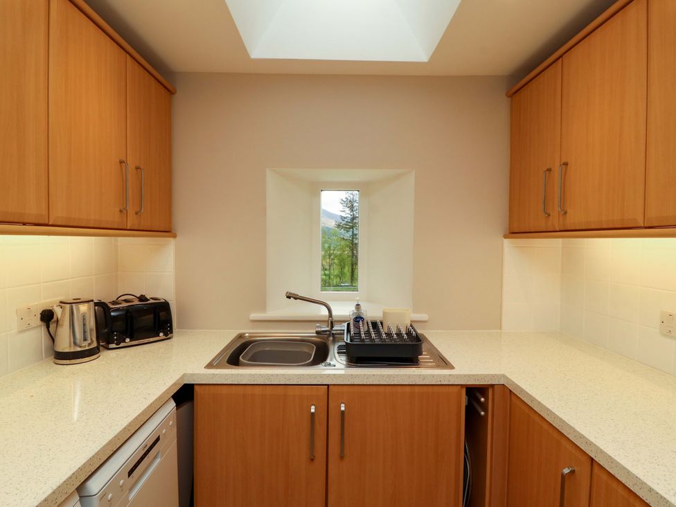 A kitchen with a sink and appliances at Swallow's Nest Thornthwaite near Braithwaite