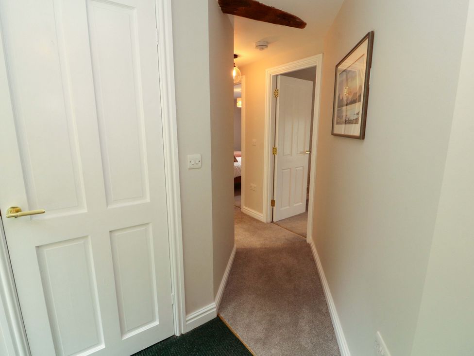 A hallway with doors leading to other rooms at Swallow's Nest Thornthwaite near Braithwaite