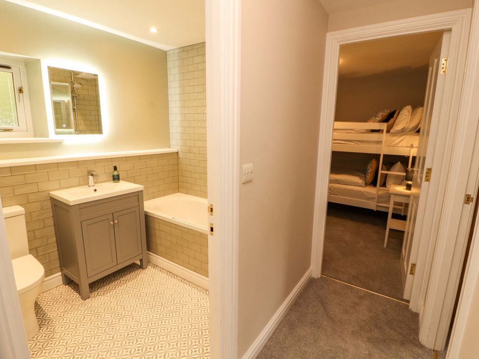 A bathroom with a washbasin and bathtub at Swallow's Nest in Thornthwaite near Braithwaite