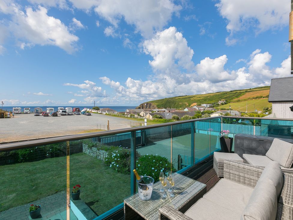 A balcony with seating and sea view at Sandbanks in Praa Sands