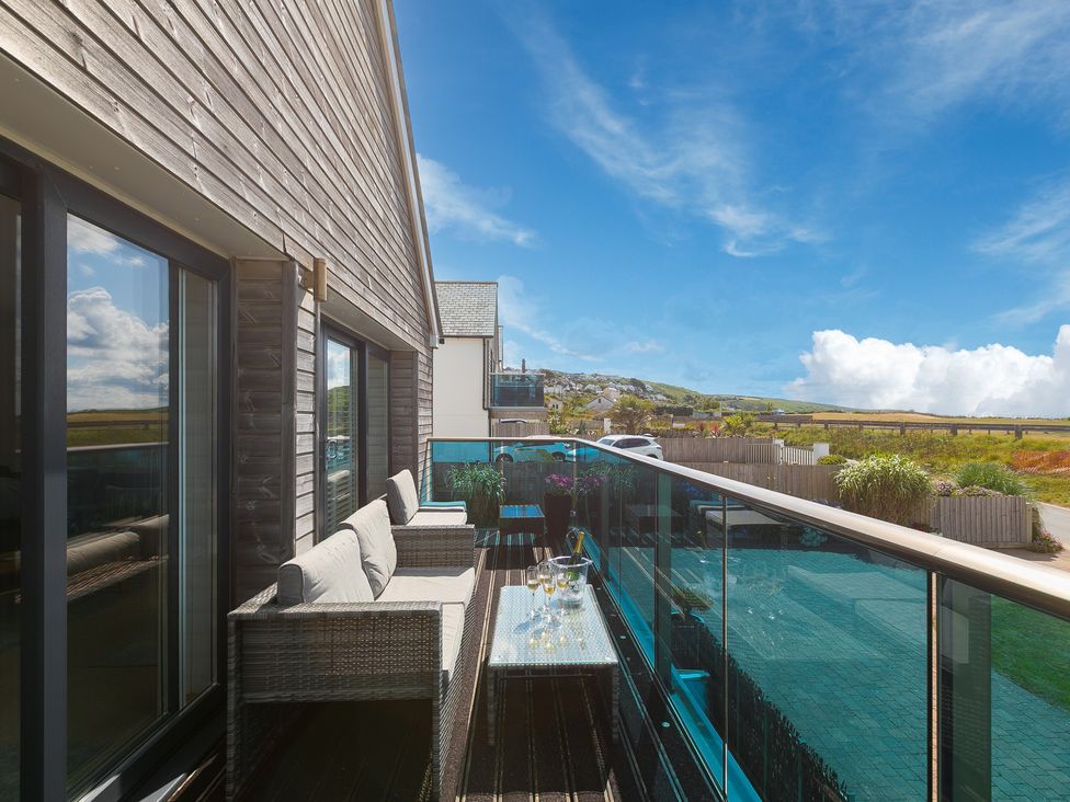 A balcony with a sofa and table at Sandbanks in Praa Sands