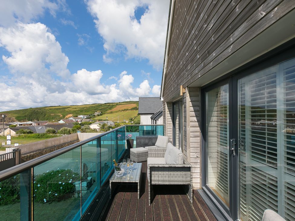 A balcony with outdoor furniture at Sandbanks in Praa Sands