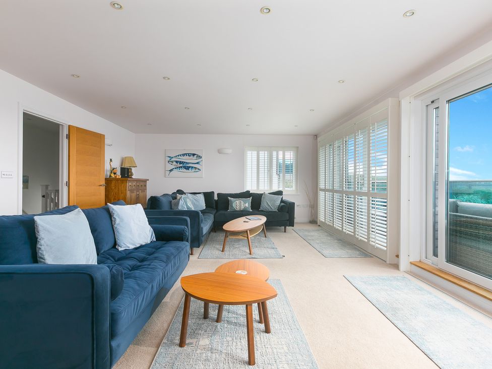 A living room with sofas and a coffee table at Sandbanks in Praa Sands