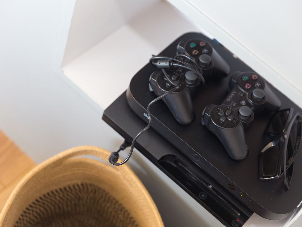 A gaming console with controllers and sunglasses at Sandbanks in Praa Sands