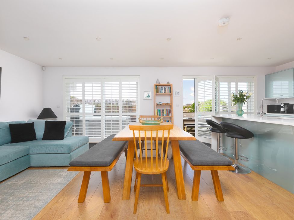 A dining area with a table and chairs at Sandbanks in Praa Sands