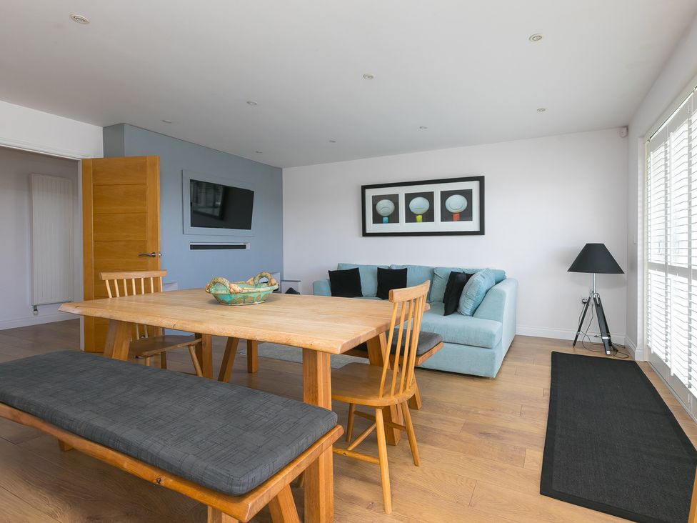 A dining room with a table and chairs at Sandbanks in Praa Sands