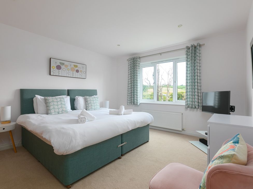 A bedroom with a bed and tv at Sandbanks in Praa Sands