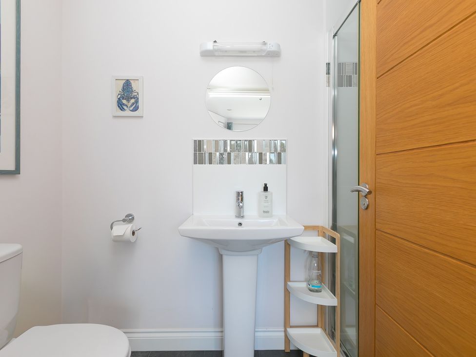 A bathroom with a sink and toilet at Sandbanks in Praa Sands
